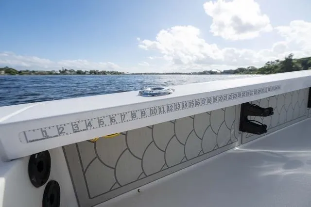 Slide: The Image of 2024 Islamorada Boatworks 24 on water, featuring a built-in measuring ruler. - 27