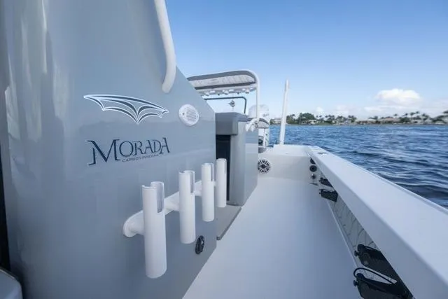 Slide: The Image of 2024 Islamorada Boatworks 24 on water, showcasing sleek design and rod holders. - 30