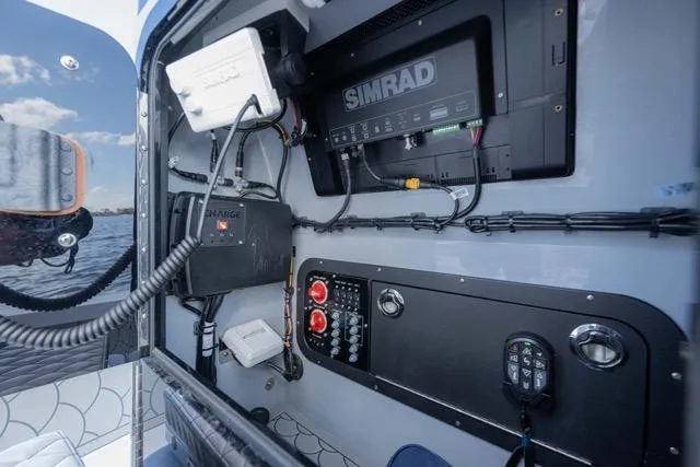 Slide: The Image of 2024 Islamorada Boatworks 24 control panel with Simrad electronics and wiring. - 31