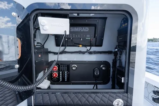 Slide: The Image of 2024 Islamorada Boatworks 24 control panel with Simrad electronics on open water. - 32