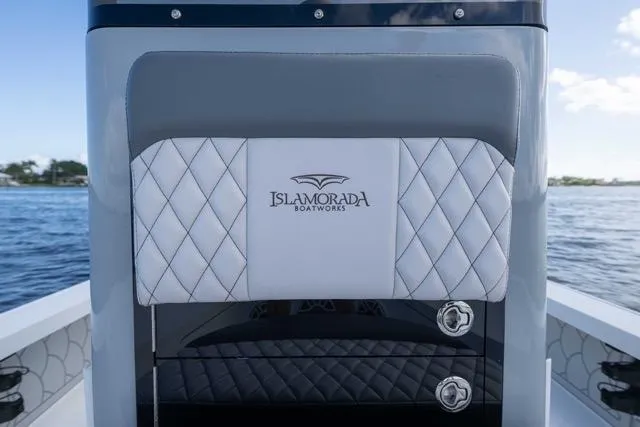 Slide: The Image of 2024 Islamorada Boatworks 24, featuring elegant diamond-stitched upholstery on a serene water backdrop. - 33