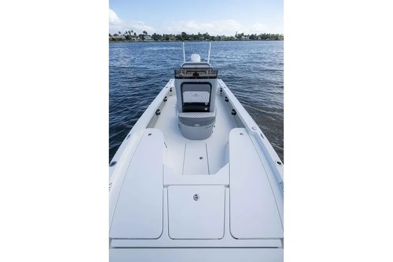 Slide: The Image of 2024 Islamorada Boatworks 24 on calm water, showcasing sleek deck design. - 34
