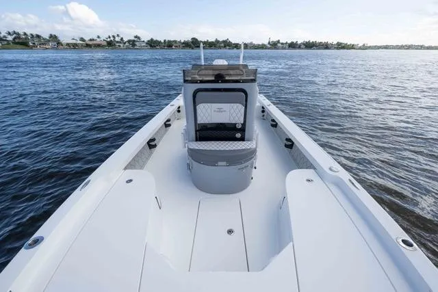 Slide: The Image of 2024 Islamorada Boatworks 24 on calm water, showcasing spacious deck and seating. - 35