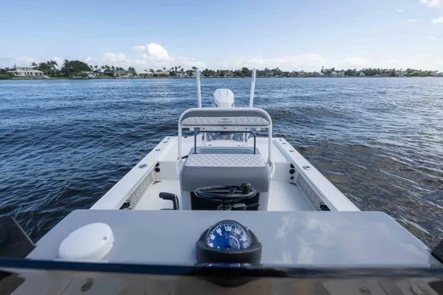 Slide: The Image of 2024 Islamorada Boatworks 24 on calm waters, showcasing helm and seating area. - 36