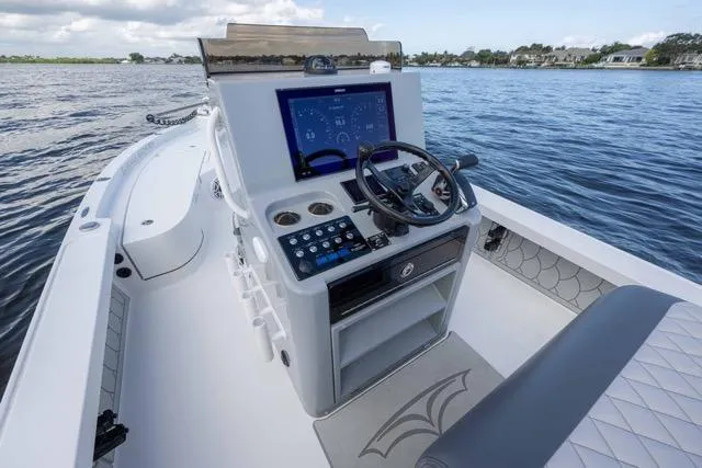 Slide: The Image of 2024 Islamorada Boatworks 24 console with advanced navigation system on calm waters. - 39