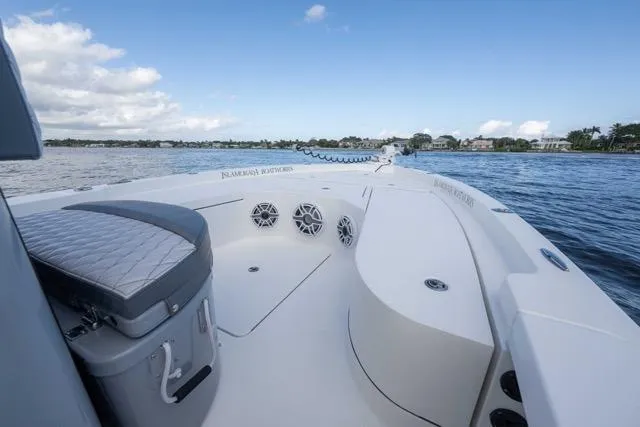 Slide: The Image of 2024 Islamorada Boatworks 24 on calm water, showcasing spacious deck and seating. - 44