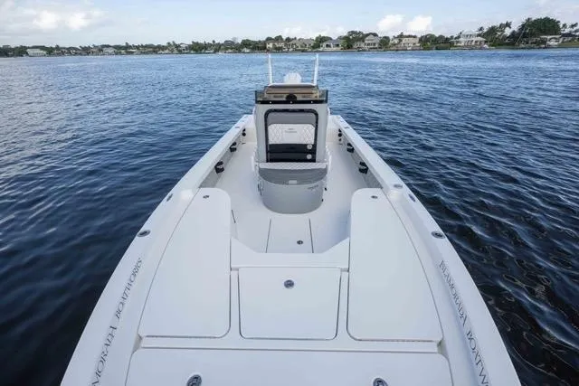 Slide: The Image of 2024 Islamorada Boatworks 24 on calm water, showcasing sleek design and spacious deck. - 45