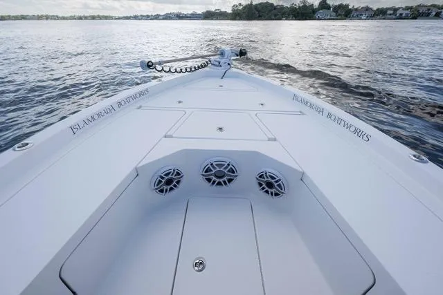 Slide: The Image of 2024 Islamorada Boatworks 24 on water, showcasing sleek design and spacious deck. - 51