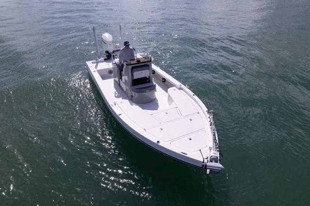 Slide: The Image of 2024 Islamorada Boatworks 24 on calm water, showcasing sleek design and modern features. - 56