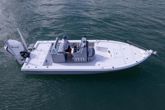 Slide: The Image of 2024 Islamorada Boatworks 24 on water, featuring sleek design and modern outboard motor. - 58