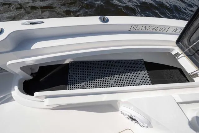 Slide: The Image of 2024 Islamorada Boatworks 24 deck with storage compartment and non-slip mat. - 7