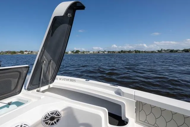 Slide: The Image of 2024 Islamorada Boatworks 24 on water, open hatch, clear sky, scenic view. - 9