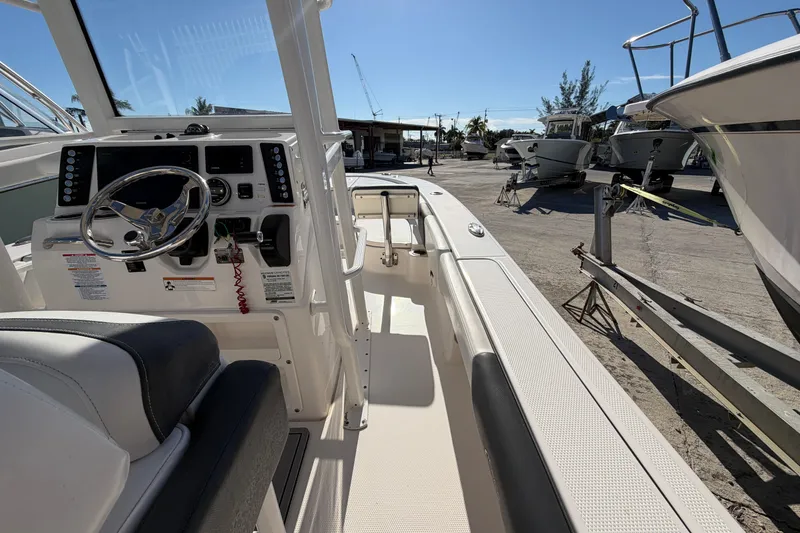 Slide: The Image of 2020 Robalo 246 Cayman SD boat interior with steering wheel and control panel. - 10
