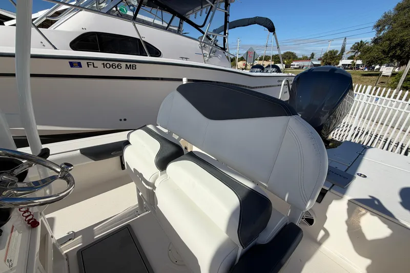 Slide: The Image of 2020 Robalo 246 Cayman SD boat interior with seating and steering wheel. - 13