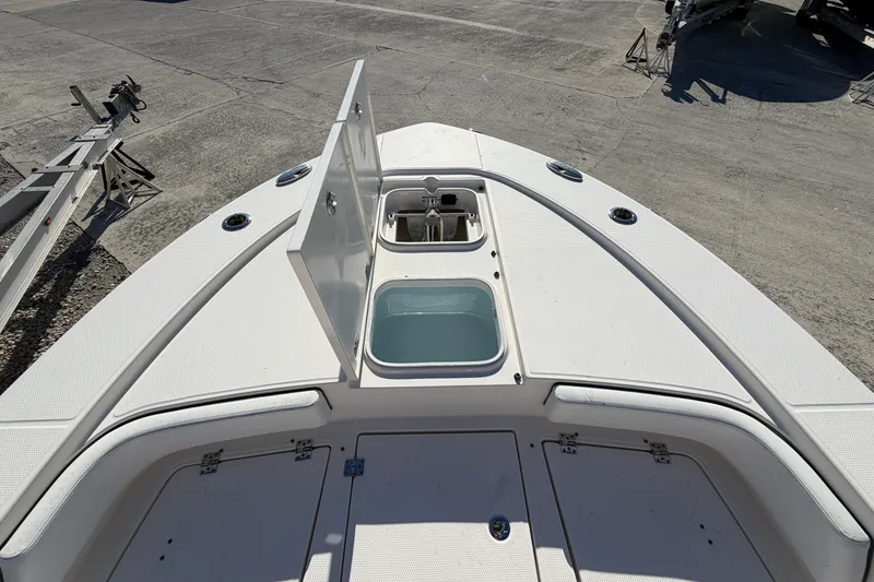 Slide: The Image of 2020 Robalo 246 Cayman SD boat deck with open storage compartment. - 17