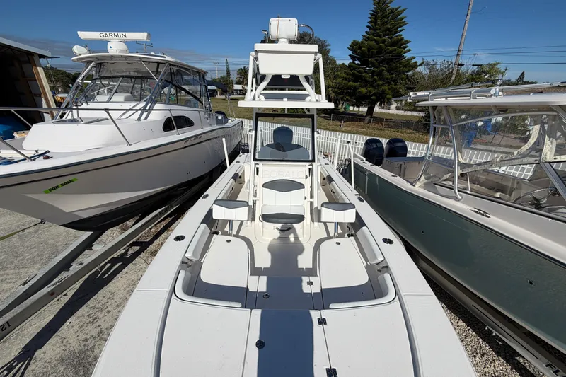 Slide: The Image of 2020 Robalo 246 Cayman SD boat displayed between two other boats. - 18