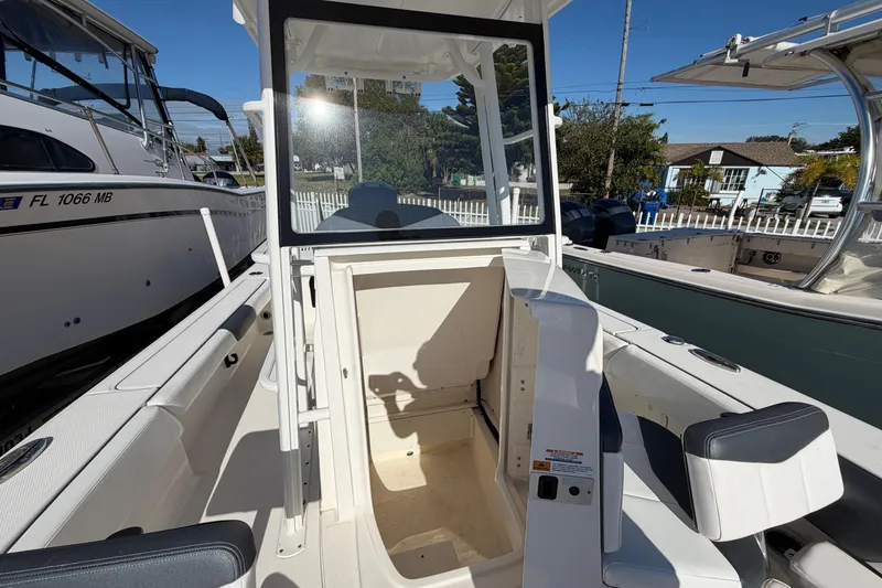 Slide: The Image of 2020 Robalo 246 Cayman SD boat interior with seating and storage area. - 19