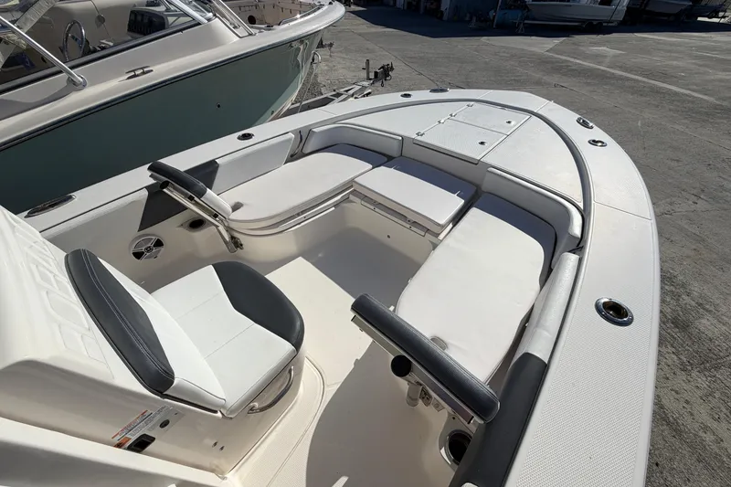 Slide: The Image of 2020 Robalo 246 Cayman SD boat interior with white seating and sleek design. - 20