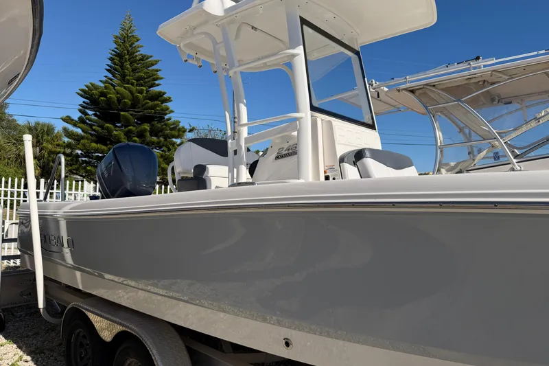 Slide: The Image of 2020 Robalo 246 Cayman SD boat with T-top and outboard motor. - 3