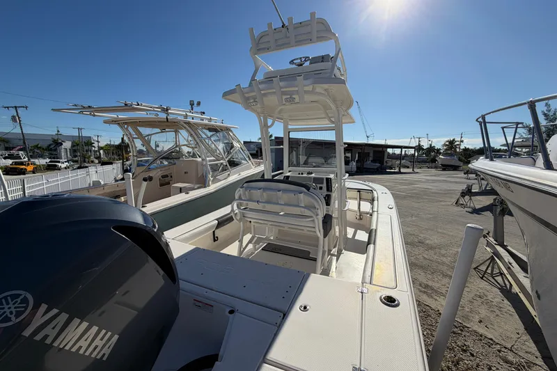Slide: The Image of 2020 Robalo 246 Cayman SD boat with Yamaha engine, docked under clear blue sky. - 4