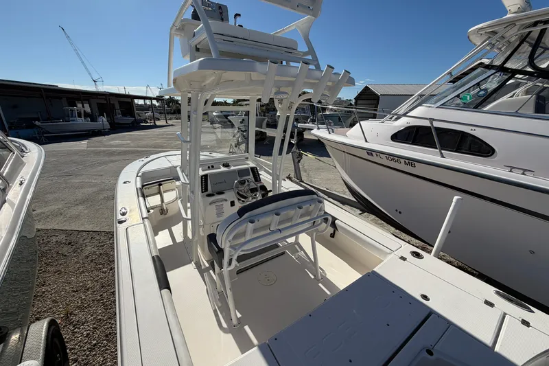 Slide: The Image of 2020 Robalo 246 Cayman SD boat docked, featuring a spacious deck and modern controls. - 6