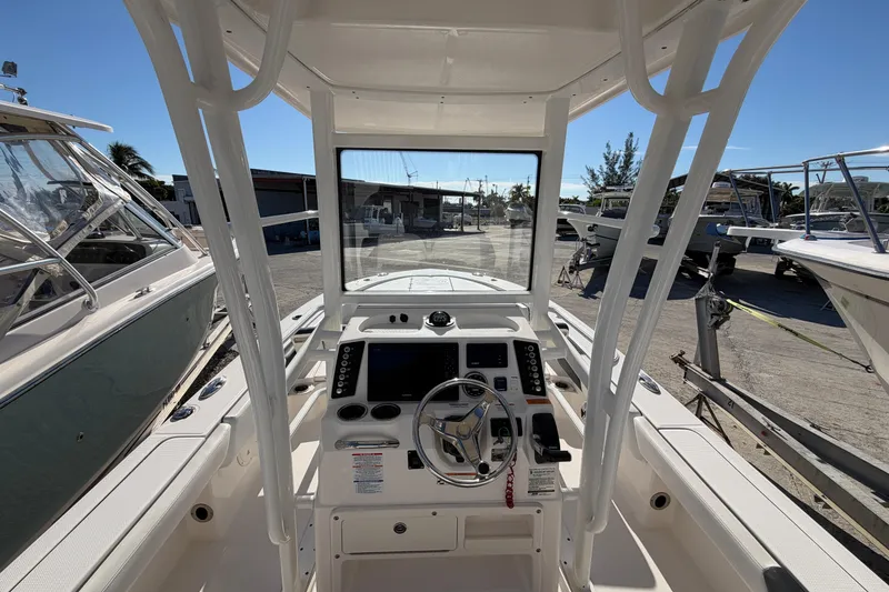 Slide: The Image of 2020 Robalo 246 Cayman SD boat cockpit with steering wheel and control panel. - 7