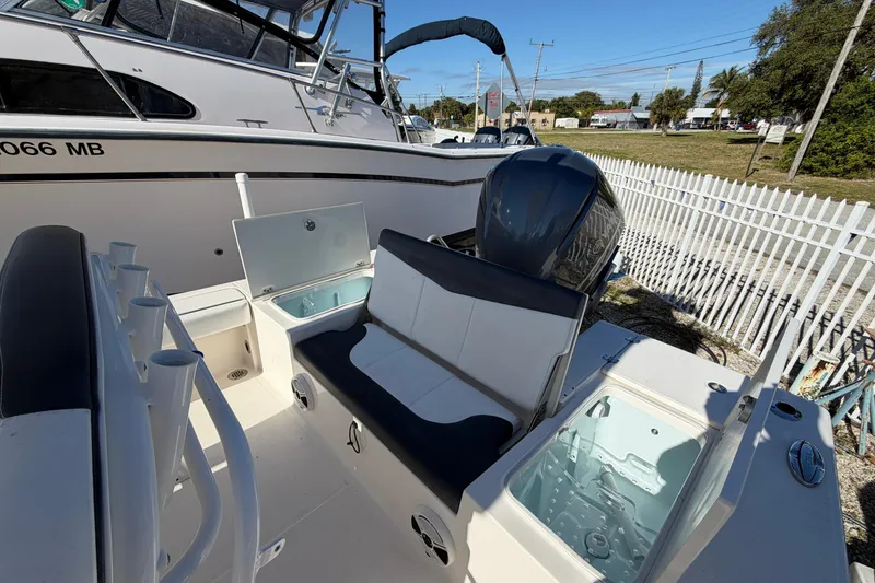 Slide: The Image of 2020 Robalo 246 Cayman SD boat interior with seating and storage compartments. - 9