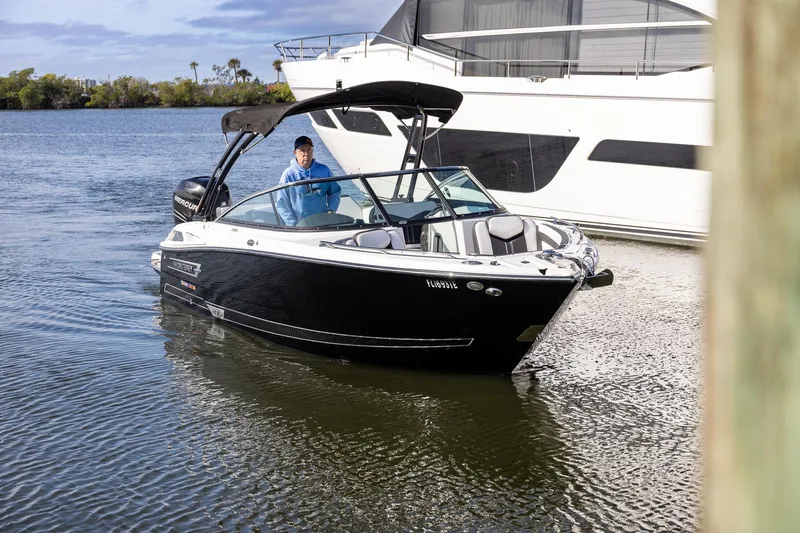 Slide: The Image of 2022 Monterey 275SS Super Sport boat on water, with a person onboard. - 14