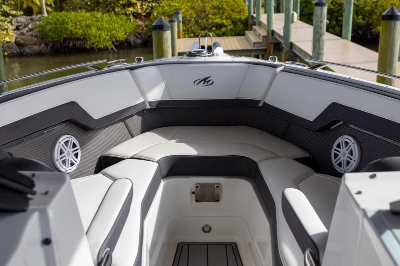 Slide: The Image of 2022 Monterey 275SS Super Sport boat interior with cushioned seating and speakers. - 15