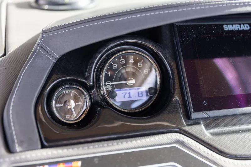 Slide: The Image of Dashboard of 2022 Monterey 275SS Super Sport boat with gauges and Simrad display. - 22