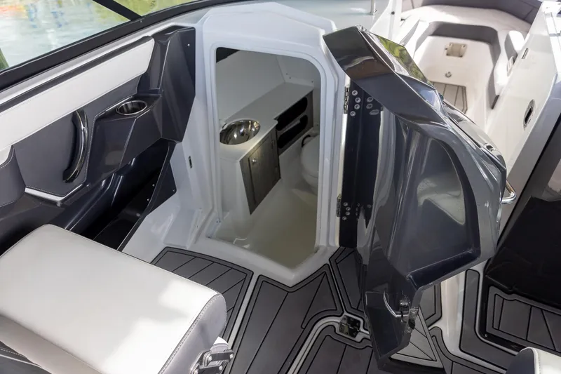 Slide: The Image of 2022 Monterey 275SS Super Sport boat interior with open cabin door and seating. - 25