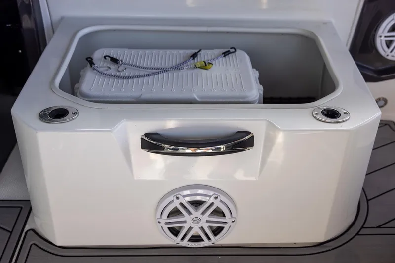 Slide: The Image of 2022 Monterey 275SS Super Sport boat cooler compartment with speaker and handle. - 45