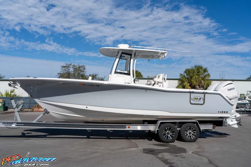 Slide: The Image of 2024 Sea Hunt Gamefish 27 boat on trailer, clear sky background. - 15