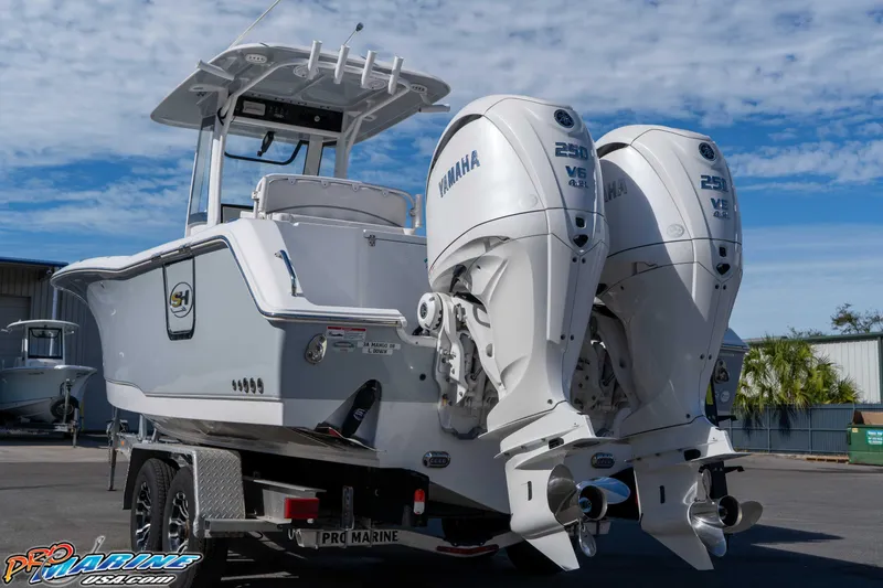Slide: The Image of 2024 Sea Hunt Gamefish 27 boat with dual Yamaha 250 V6 engines on a trailer. - 17