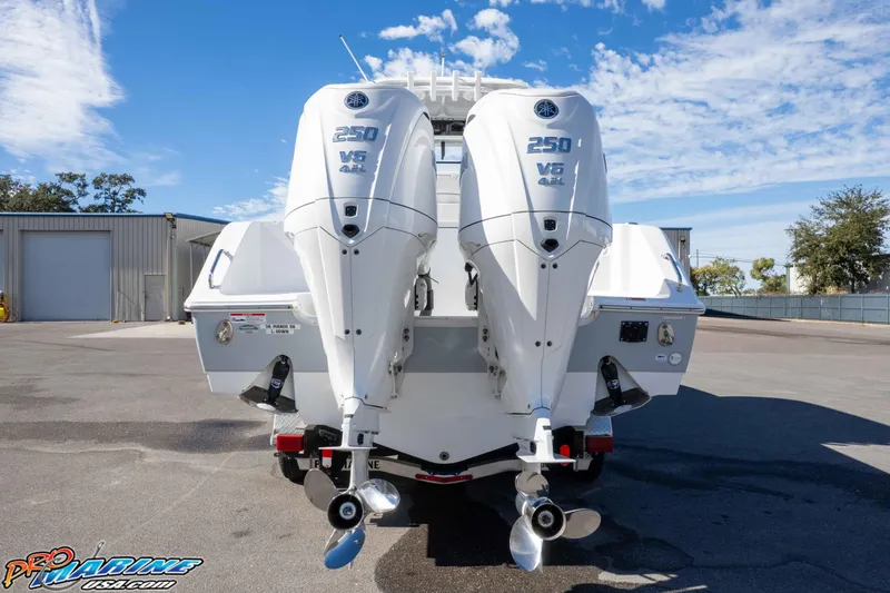 Slide: The Image of 2024 Sea Hunt Gamefish 27 with dual Yamaha 250 V6 engines, parked outdoors. - 18