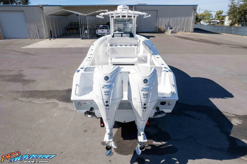 Slide: The Image of 2024 Sea Hunt Gamefish 27 boat with dual Yamaha 250 engines, parked outdoors. - 20