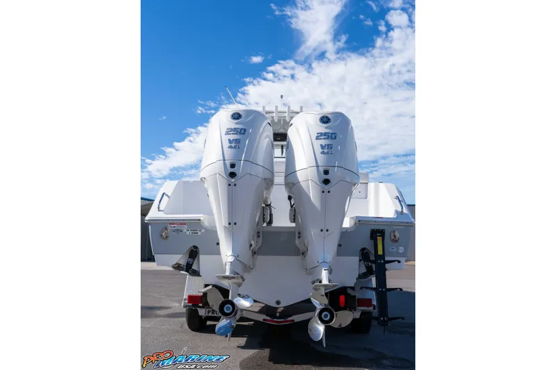 Slide: The Image of 2024 Sea Hunt Gamefish 27 with dual 250 V6 outboard engines, under a clear blue sky. - 21