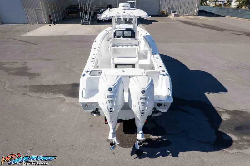 Slide: The Image of 2024 Sea Hunt Gamefish 27 boat with dual engines, parked on concrete surface. - 22
