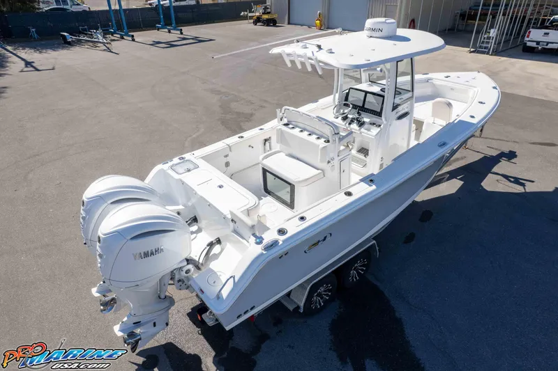 Slide: The Image of 2024 Sea Hunt Gamefish 27 boat with dual Yamaha engines, parked on a trailer. - 28