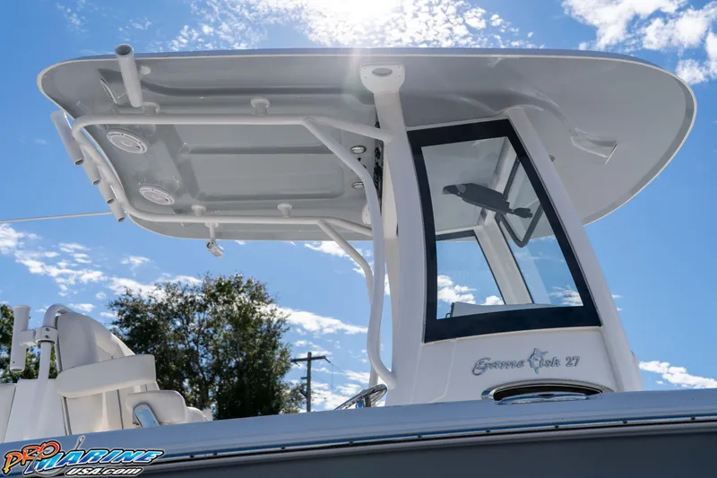Slide: The Image of 2024 Sea Hunt Gamefish 27 boat with T-top and clear sky background. - 29