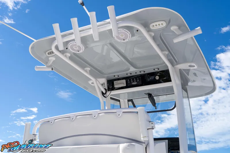Slide: The Image of 2024 Sea Hunt Gamefish 27 boat with rod holders and speakers under a clear blue sky. - 31