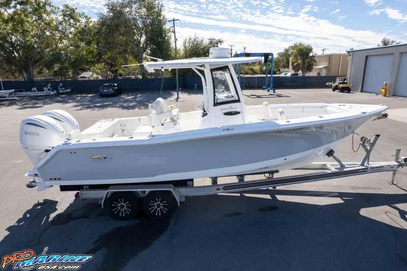 Slide: The Image of 2024 Sea Hunt Gamefish 27 boat on trailer in sunny outdoor setting. - 32