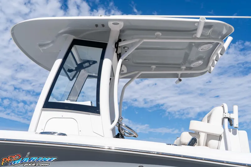 Slide: The Image of 2024 Sea Hunt Gamefish 27 boat with T-top against a blue sky background. - 33