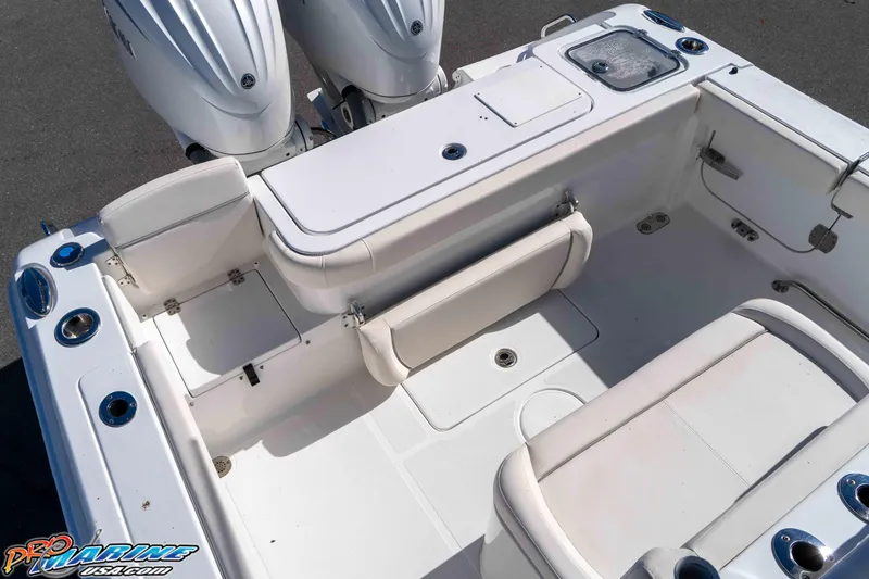 Slide: The Image of 2024 Sea Hunt Gamefish 27 boat interior with dual engines and seating area. - 37