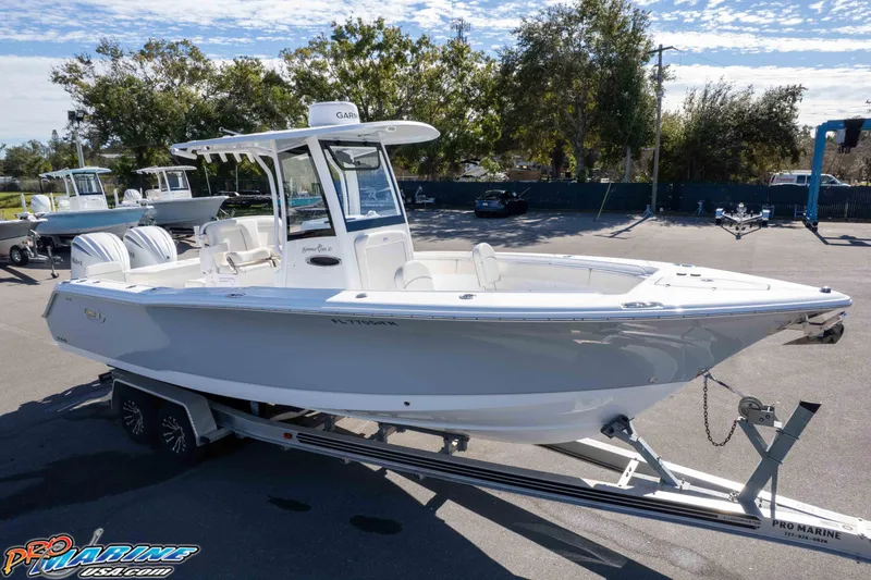 Slide: The Image of 2024 Sea Hunt Gamefish 27 boat on trailer, displayed outdoors. - 38