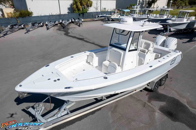 Slide: The Image of 2024 Sea Hunt Gamefish 27 boat on trailer in a marina setting. - 4