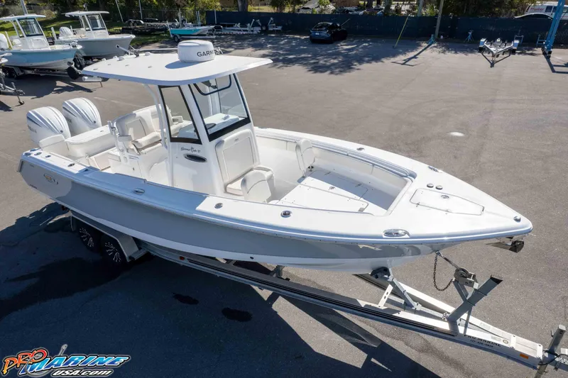Slide: The Image of 2024 Sea Hunt Gamefish 27 boat on trailer, displayed outdoors. - 40