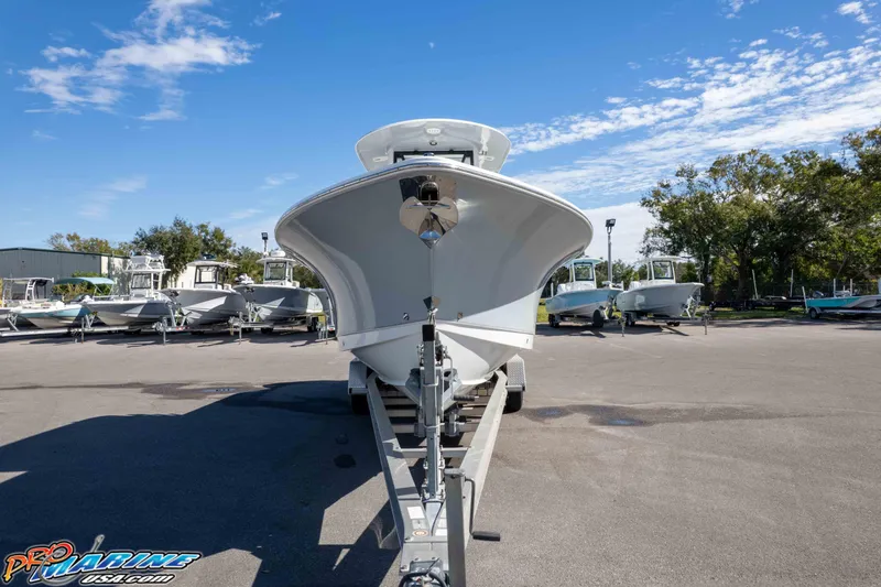 Slide: The Image of 2024 Sea Hunt Gamefish 27 boat on trailer in a sunny outdoor lot. - 42
