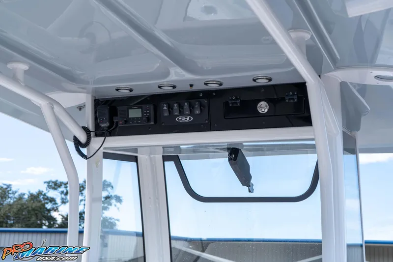 Slide: The Image of 2024 Sea Hunt Gamefish 27 boat console with electronic controls and storage. - 47