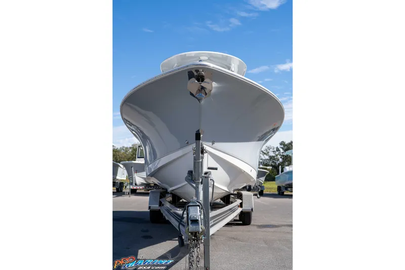 Slide: The Image of 2024 Sea Hunt Gamefish 27 boat on trailer, viewed from the front under a clear blue sky. - 7